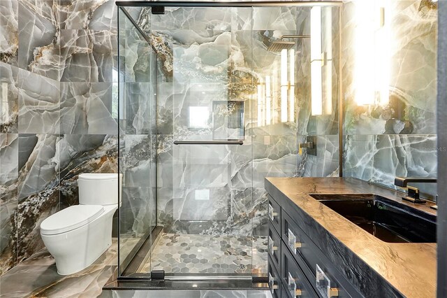5525 Isleworth Country Club Dr, Windermere, FL 34786 - full bath featuring tile walls, marble tiled floors, vanity, a marble finish shower, and toilet
