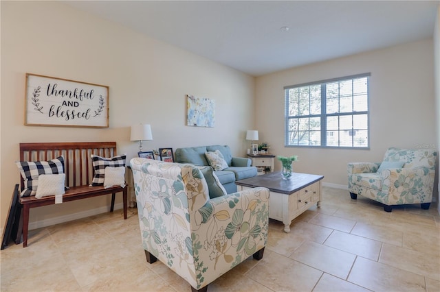 living area featuring baseboards and light tile patterned floors
