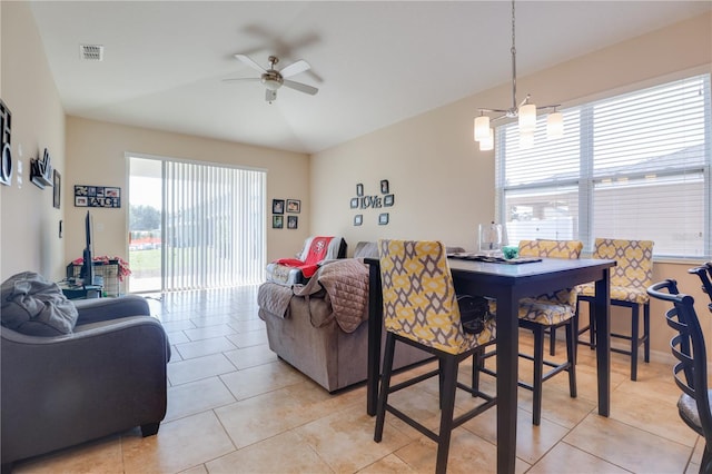 dining area with light tile patterned floors, ceiling fan, vaulted ceiling, and visible vents