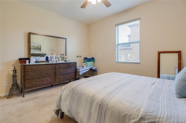 bedroom with ceiling fan and light colored carpet