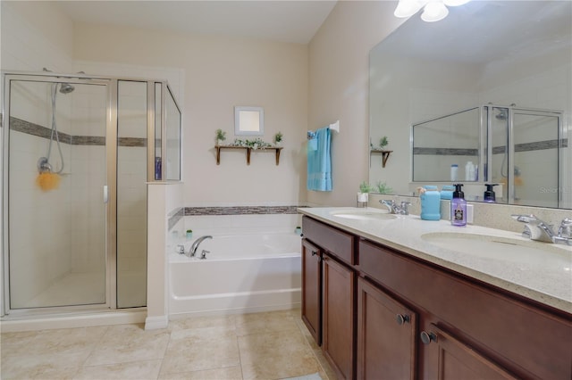 bathroom with a garden tub, a sink, a stall shower, and double vanity