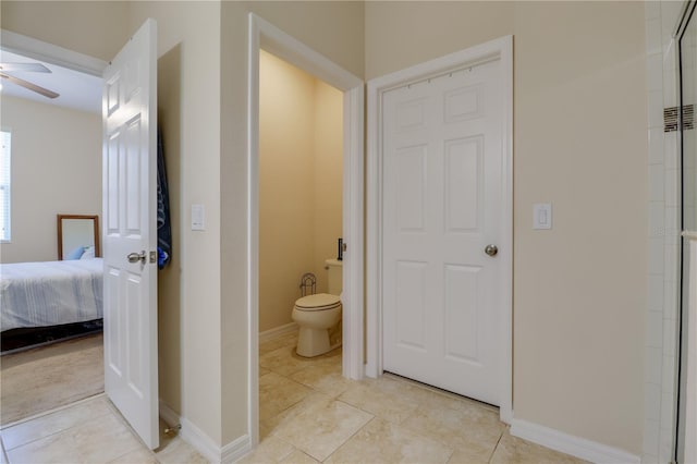 full bathroom featuring connected bathroom, toilet, ceiling fan, and tile patterned floors