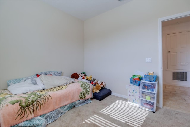 bedroom with baseboards, visible vents, and carpet