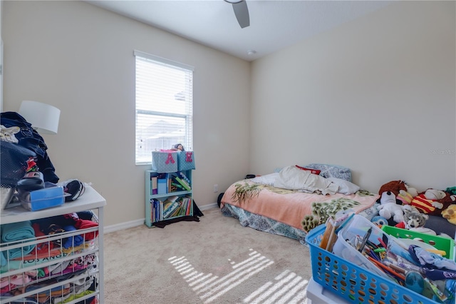 carpeted bedroom featuring baseboards and a ceiling fan