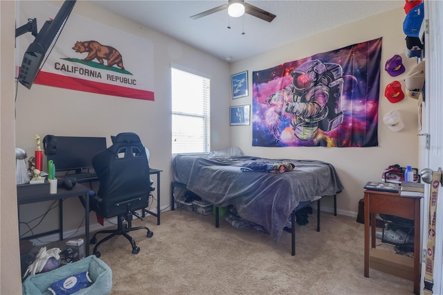 carpeted bedroom featuring ceiling fan and baseboards