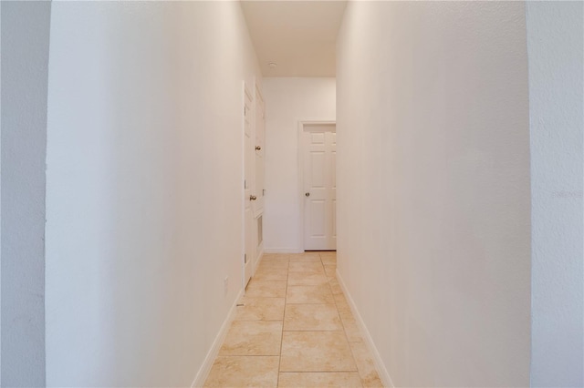 corridor featuring light tile patterned flooring