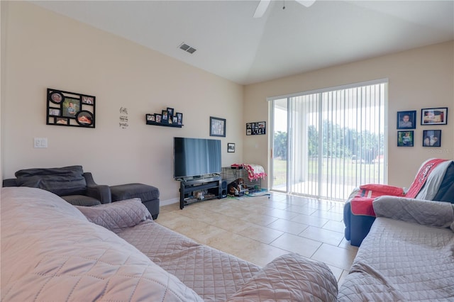 living room with visible vents, baseboards, ceiling fan, light tile patterned floors, and vaulted ceiling