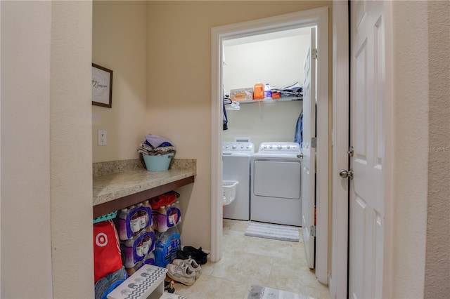laundry area with separate washer and dryer, laundry area, and light tile patterned flooring