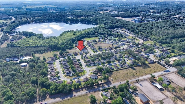 bird's eye view featuring a water view and a wooded view