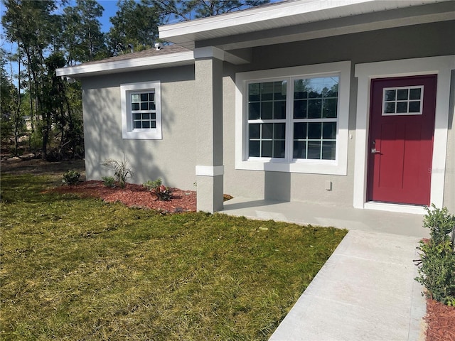 8312 N Pitcairn Way, Citrus Springs, FL 34434 - entrance to property with stucco siding and a lawn
