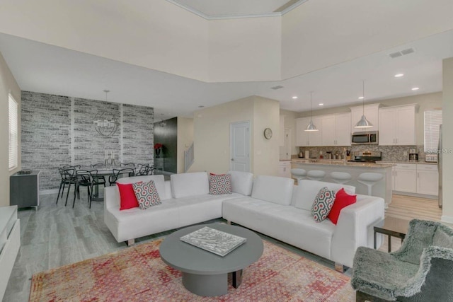 living room featuring light wood finished floors and visible vents