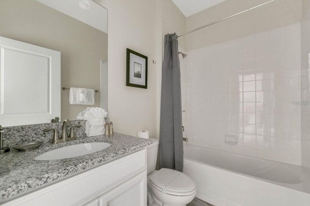 bathroom featuring vanity, toilet, and shower / tub combo with curtain