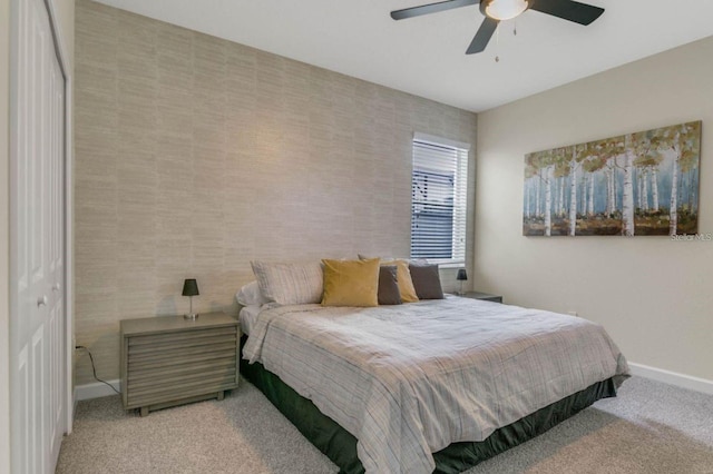 carpeted bedroom featuring baseboards and a ceiling fan