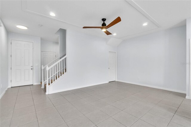 spare room with baseboards, stairway, recessed lighting, a ceiling fan, and light tile patterned floors