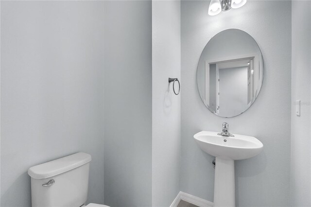 half bathroom featuring toilet