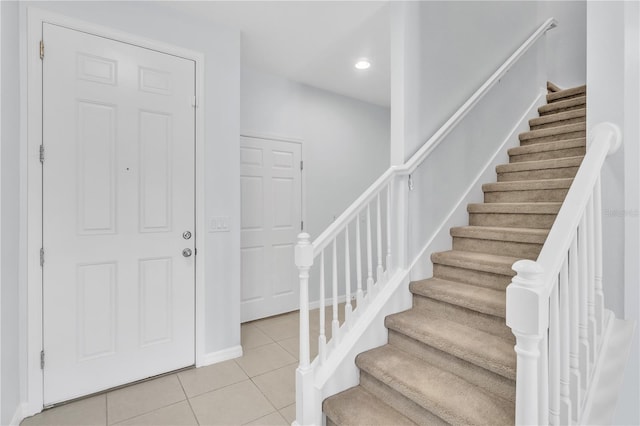 entryway featuring recessed lighting, baseboards, light tile patterned floors, and stairway