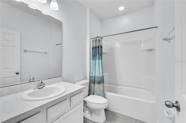 bathroom featuring toilet, shower / bath combination with curtain, tile patterned flooring, and vanity