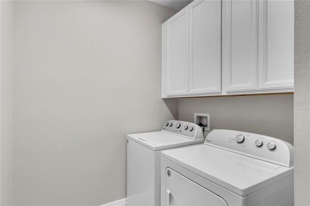 laundry area with cabinet space and washer and clothes dryer