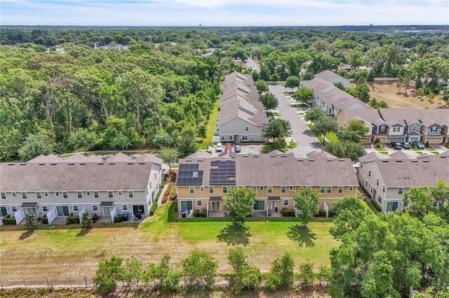 birds eye view of property featuring a view of trees and a residential view