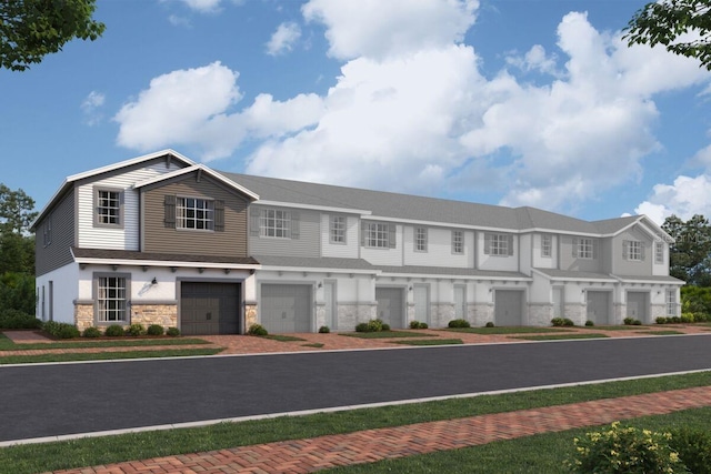 view of building exterior with an attached garage and driveway
