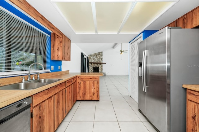3379 Monika Cir, Orlando, FL 32812 - kitchen with a sink, a fireplace, light countertops, stainless steel appliances, and open floor plan
