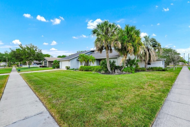 3379 Monika Cir, Orlando, FL 32812 - view of front of home featuring a garage, stucco siding, concrete driveway, and a front yard
