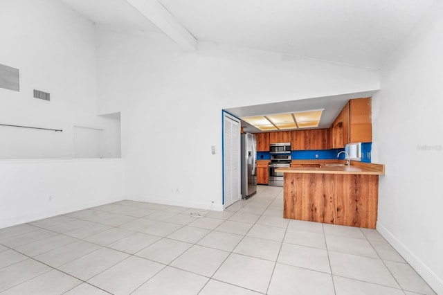 3379 Monika Cir, Orlando, FL 32812 - kitchen featuring brown cabinetry, visible vents, appliances with stainless steel finishes, light countertops, and high vaulted ceiling