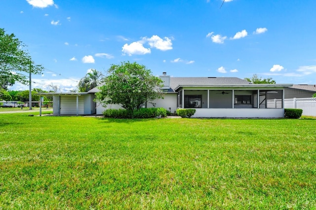 3379 Monika Cir, Orlando, FL 32812 - rear view of property featuring a yard, fence, a chimney, and a sunroom