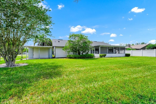3379 Monika Cir, Orlando, FL 32812 - rear view of house featuring a sunroom, fence, and a yard