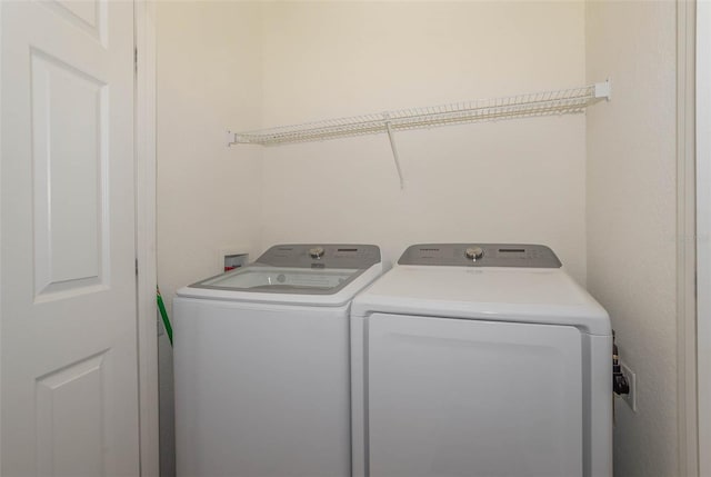 laundry room with laundry area and washer and clothes dryer
