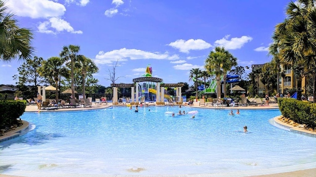 pool with a patio area and a pergola
