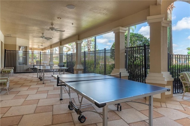 recreation room featuring a ceiling fan and decorative columns