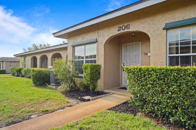 206 Diamond Cv Unit 106, Casselberry, FL 32707 - doorway to property featuring central air condition unit and stucco siding