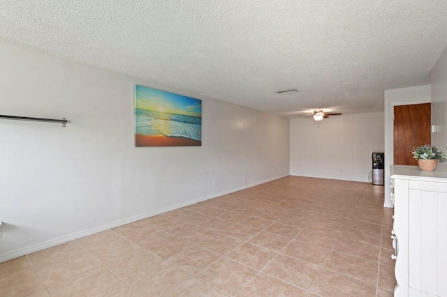 206 Diamond Cv Unit 106, Casselberry, FL 32707 - empty room featuring baseboards, a ceiling fan, a textured ceiling, and light tile patterned floors
