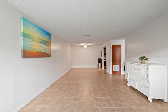 206 Diamond Cv Unit 106, Casselberry, FL 32707 - corridor with light tile patterned flooring, a textured ceiling, visible vents, and baseboards
