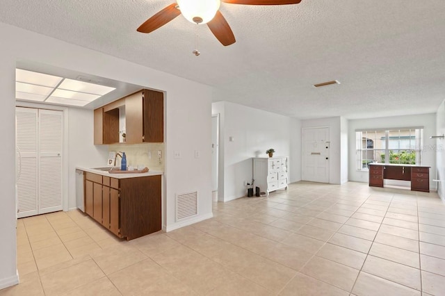 206 Diamond Cv Unit 106, Casselberry, FL 32707 - kitchen with light tile patterned flooring, light countertops, a ceiling fan, open floor plan, and visible vents