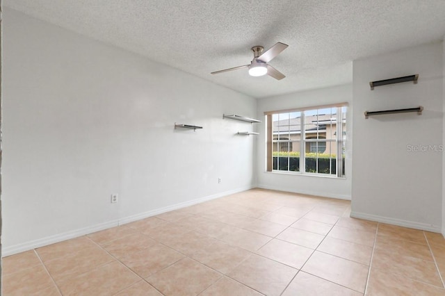 206 Diamond Cv Unit 106, Casselberry, FL 32707 - empty room featuring baseboards, a ceiling fan, a textured ceiling, and light tile patterned floors
