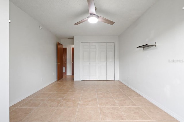 206 Diamond Cv Unit 106, Casselberry, FL 32707 - unfurnished bedroom with baseboards, a ceiling fan, a closet, and light tile patterned flooring