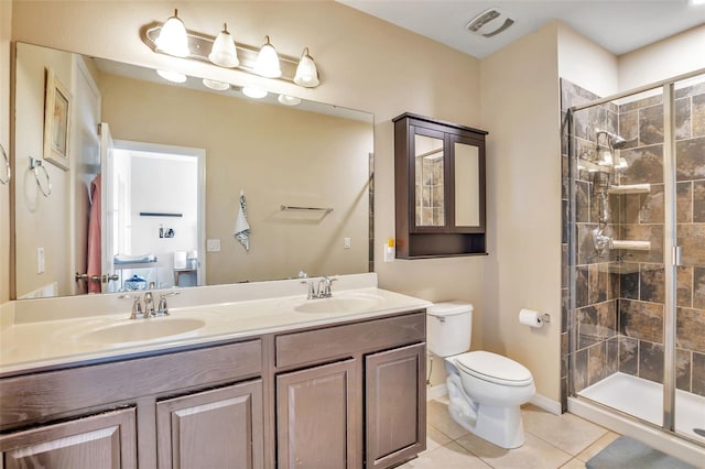 bathroom featuring double vanity, a stall shower, a sink, tile patterned floors, and toilet