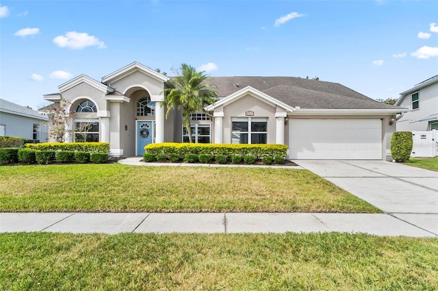 633 Lakehaven Cir, Orlando, FL 32828 - view of front of house featuring stucco siding, an attached garage, concrete driveway, and a front lawn