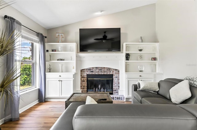 633 Lakehaven Cir, Orlando, FL 32828 - living room with vaulted ceiling, wood finished floors, baseboards, and a fireplace