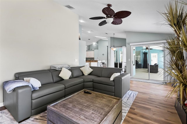 633 Lakehaven Cir, Orlando, FL 32828 - living area featuring a ceiling fan, lofted ceiling, and light wood-type flooring