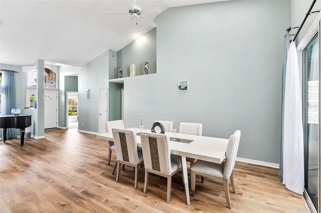 633 Lakehaven Cir, Orlando, FL 32828 - dining space with high vaulted ceiling, a ceiling fan, light wood-style floors, and baseboards