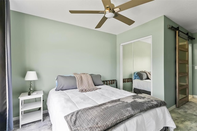 633 Lakehaven Cir, Orlando, FL 32828 - bedroom featuring a closet, a barn door, baseboards, and carpet flooring