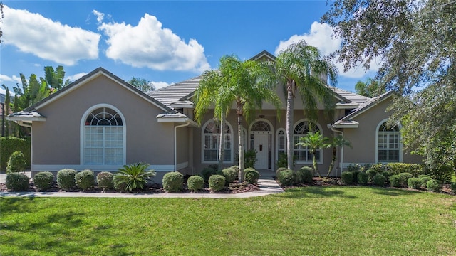 2232 Lake Vilma Dr, Orlando, FL 32835 - view of front of property featuring a tiled roof, a front yard, and stucco siding