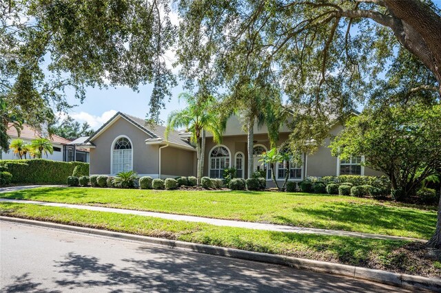 2232 Lake Vilma Dr, Orlando, FL 32835 - view of front of home featuring a front lawn and stucco siding