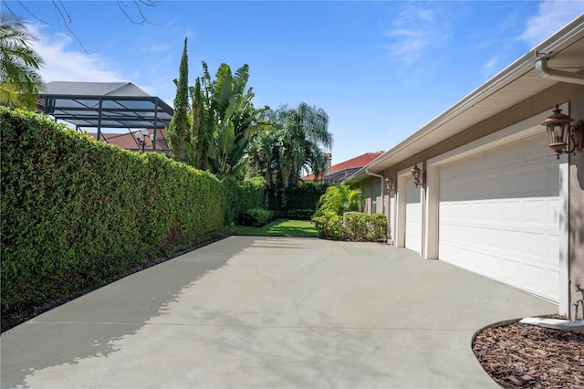2232 Lake Vilma Dr, Orlando, FL 32835 - view of patio with an attached garage and driveway