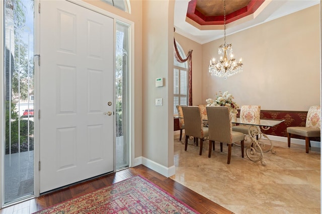 2232 Lake Vilma Dr, Orlando, FL 32835 - foyer entrance with crown molding, baseboards, an inviting chandelier, and wood finished floors