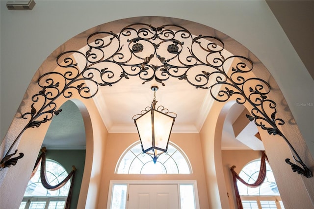 2232 Lake Vilma Dr, Orlando, FL 32835 - room details featuring crown molding, arched walkways, an inviting chandelier, and visible vents