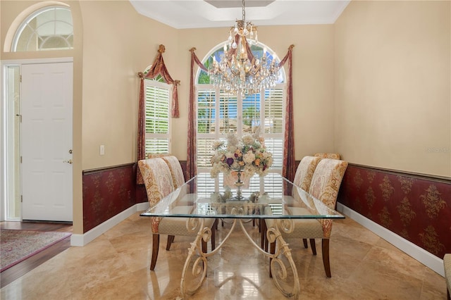 2232 Lake Vilma Dr, Orlando, FL 32835 - dining space featuring baseboards, crown molding, and a notable chandelier